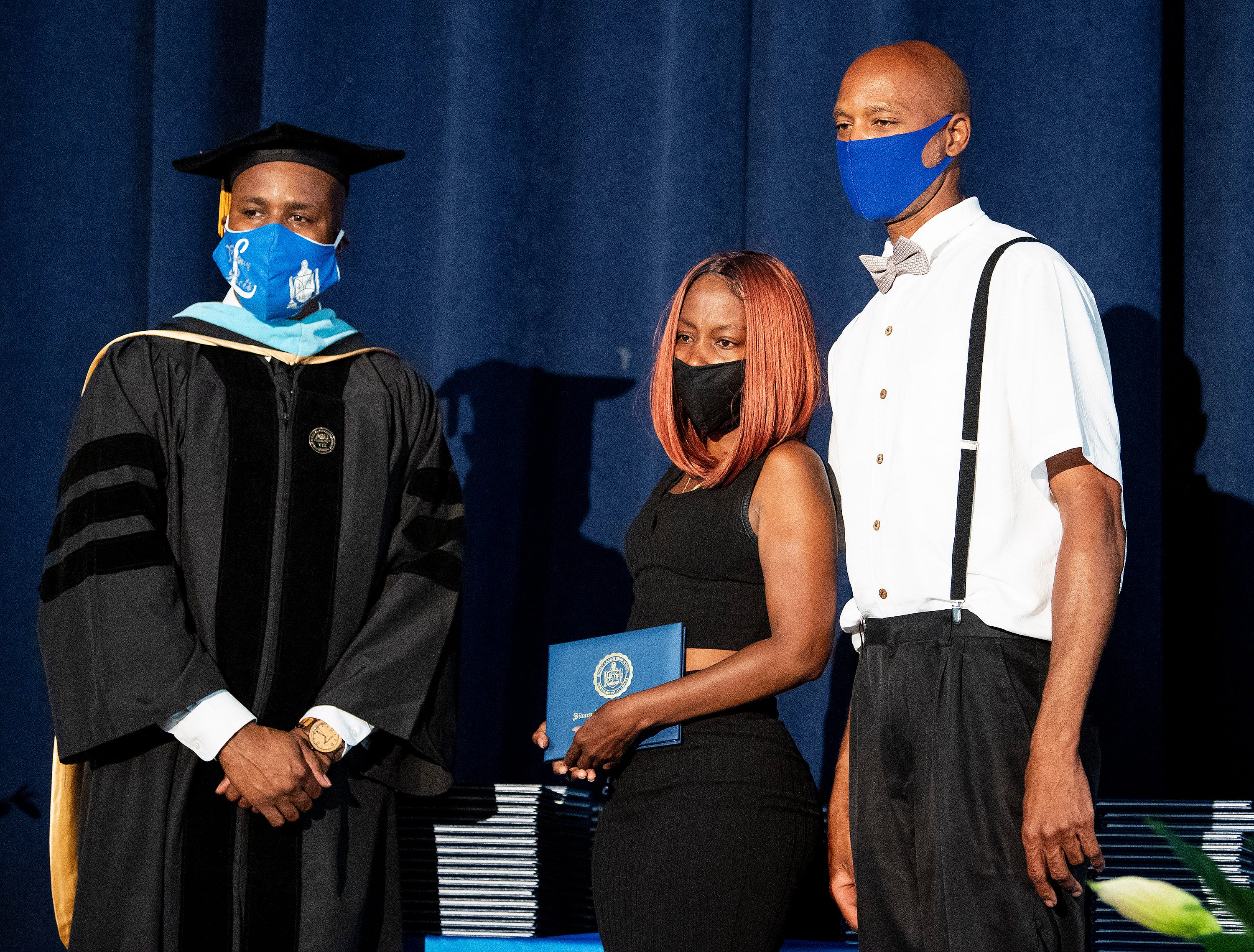 Lanier High School Principal Antonio Williams gives an honorary degree to the parents of slain Lanier student Courtney Jones as the school holds graduation exercises in the auditorium at the school in Montgomery, Ala., on Friday June 5, 2020. The graduation was distanced because of the coronavirus outbreak.