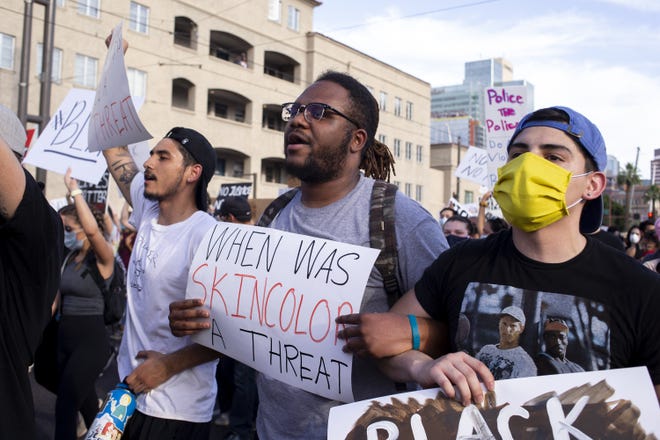 From left: Issac Ramirez, Cam Taylor, and Jacob Fajardo march during a protest against police brutality on June 4, 2020, in downtown Phoenix.