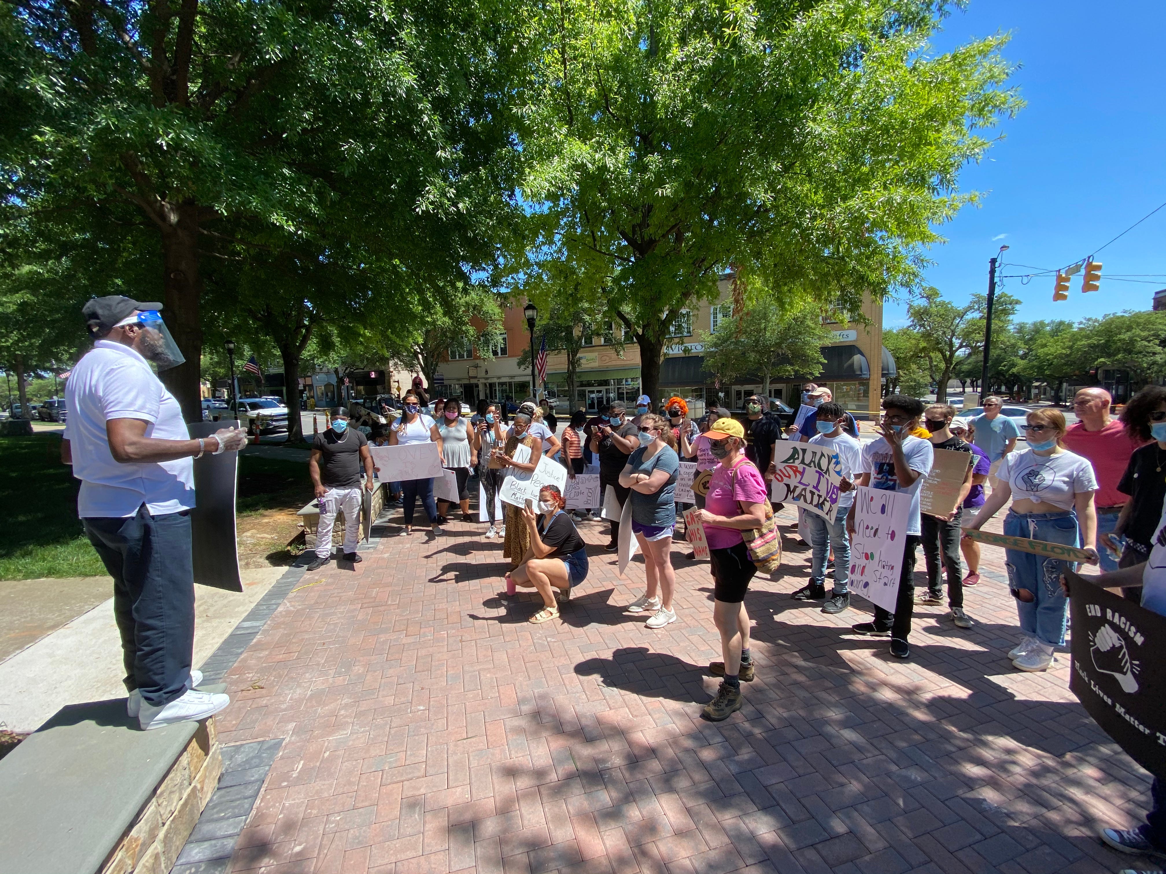 The Rev. Billy Houze speaks to a group of protestors that assembled Sunday.