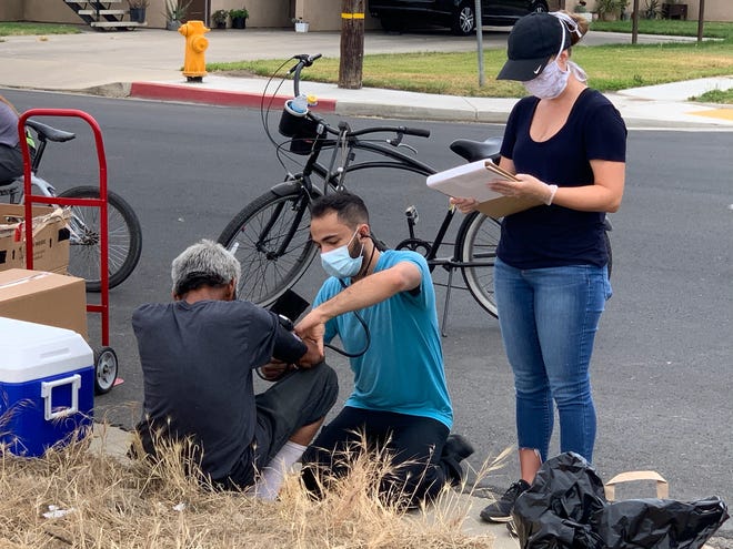 Kaweah Delta Street Medicine team tests people for COVID-19 at a homeless encampment in Tulare on Friday, June 5, 2020.