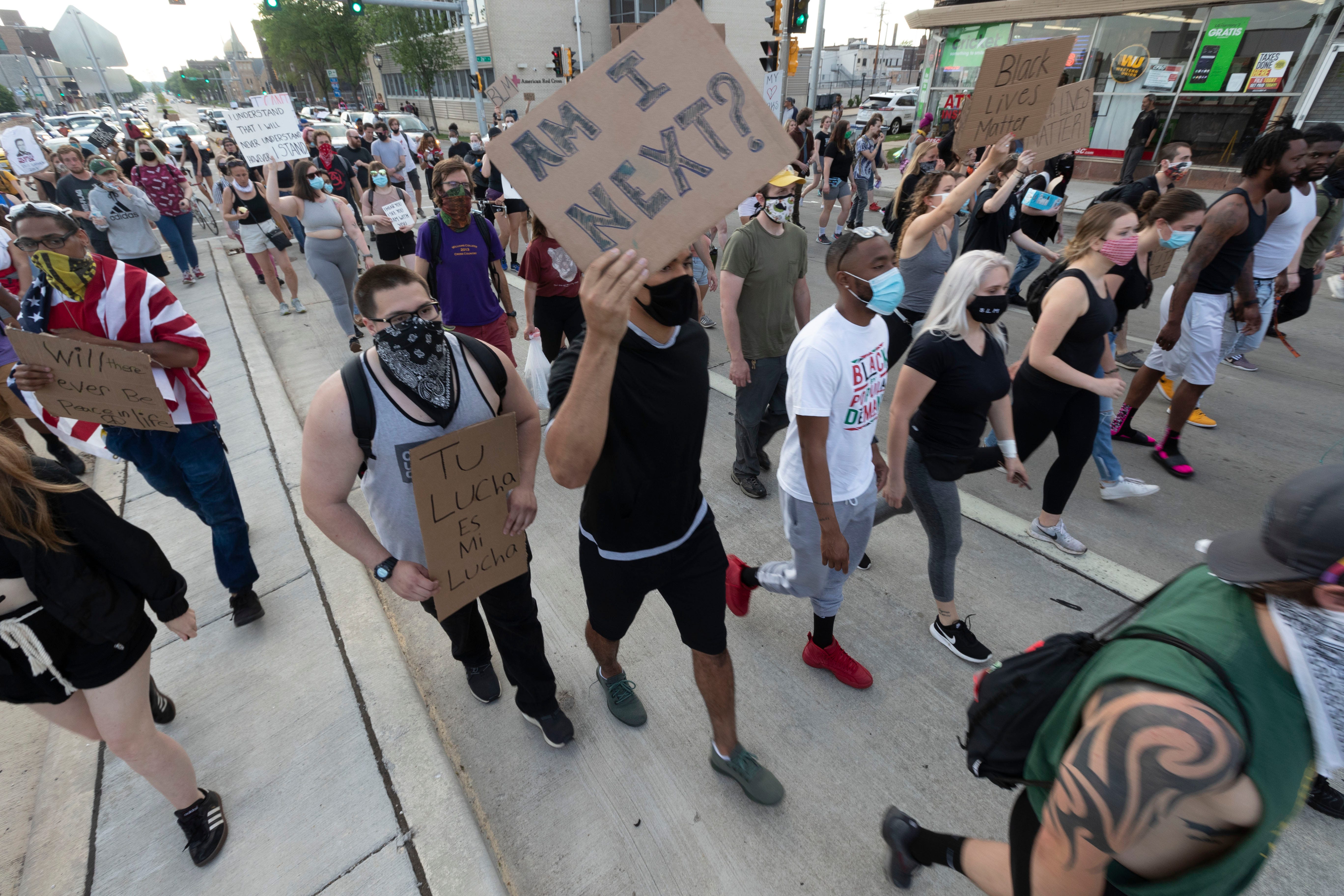 About 200 marchers make their way east on Wisconsin Ave. as part of a Black Lives Matter protest Friday, June 5, 2020 Milwaukee, Wis.