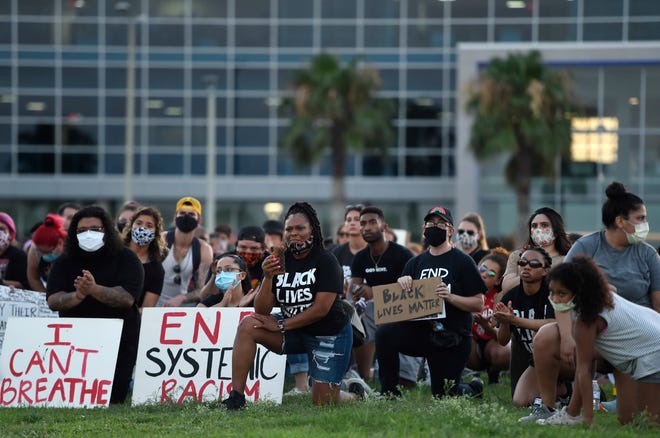Protesters kneel during an 8-minute moment of silence during the Corpus Christi Black Leadership Standing in Solidarity event, Saturday, June 6, 2020, in downtown Corpus Christi. The group was protesting the death of George Floyd and the use of excessive force by police.