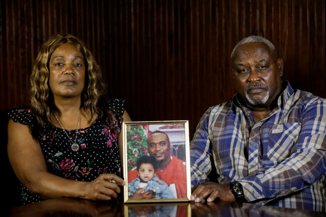 Maritza and Javier Ambler sit next to a photograph of their son, Javier Ambler II, on June 3, 2020. Their son died after being Tased by sheriff's deputies March 28, 2019. The couple said the county sheriff's office has given them no details about their son's death. "We need some closure," Javier Ambler said. "And we want justice."