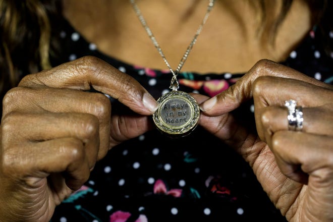 Maritza Ambler wears a necklace that holds her son's ashes. "Always in my heart," it reads.