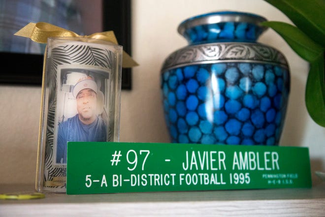 Javier Ambler II played football in high school and college. Mementos of those days sit next to an urn holding his ashes at his parents' home in Killeen, Texas.