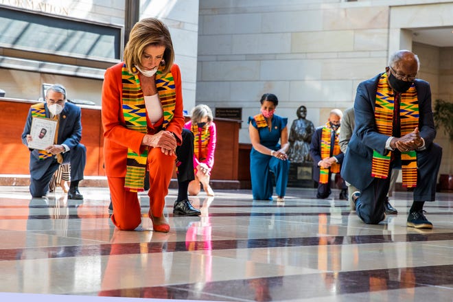 House Speaker Nancy Pelosi, D-Calif., center, and other members of Congress, kneel and observe a moment of silence at the Capitol's Emancipation Hall, Monday, June 8, 2020, on Capitol Hill in Washington, reading the names of George Floyd and others killed during police interactions.