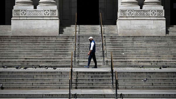 A man walks passed the Library in Manhattan on May