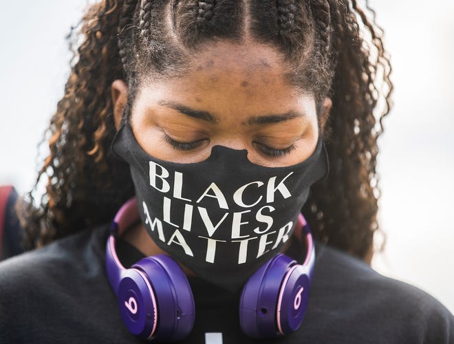 April Sherrod joins hundreds as they wait in line to pay their respect to George Floyd during a public memorial service on Monday, June 8, 2020 at The Fountain of Praise Church, in Houston.