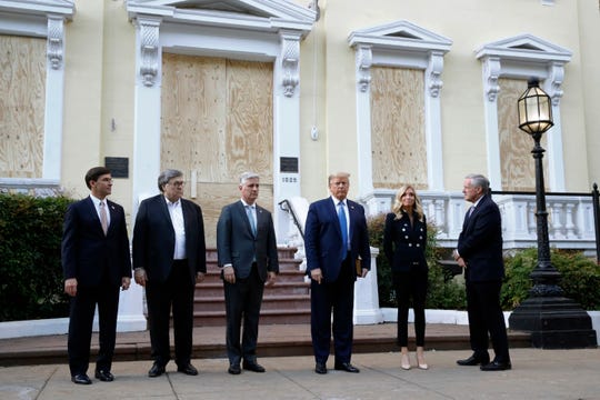 President Donald Trump stands outside St. John's Church across Lafayette Park from the White House Monday, June 1, 2020, in Washington. Part of the church was set on fire during protests on Sunday night. Standing with Trump are Defense Secretary Mark Esper, from left, Attorney General William Barr, White House national security adviser Robert O'Brien, White House press secretary Kayleigh McEnany and White House chief of staff Mark Meadows.