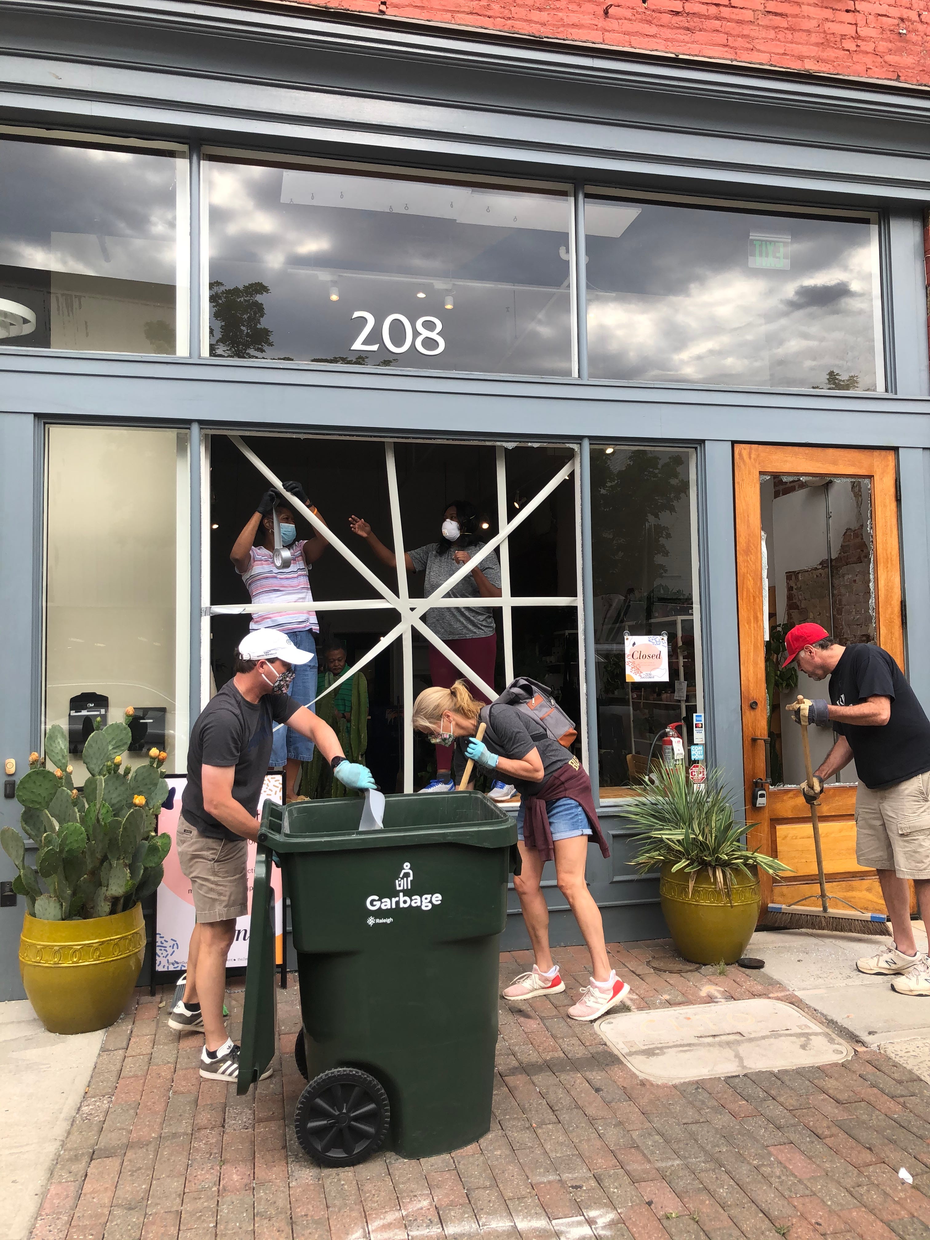 The community came out to help Megan George Cain clean up after looters broke into her shop The ZEN Succulent in downtown Raleigh, North Carolina.