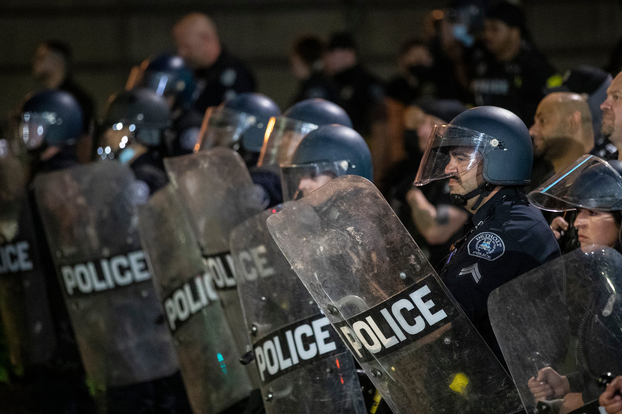  Detroit Police officers in riot gear watch protesters in downtown Detroit, Friday, May 29, 2020.