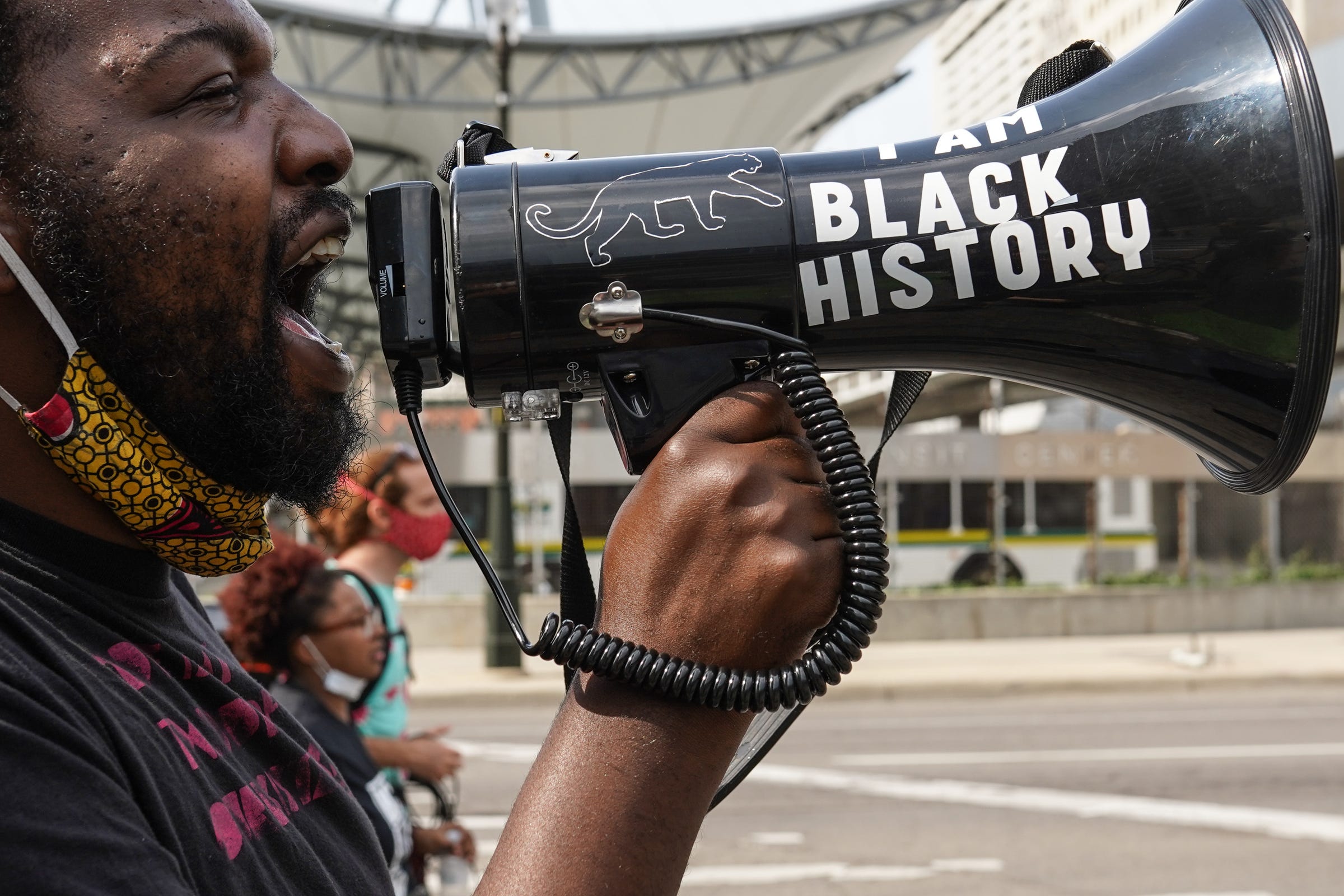 BAMN organizer Tabrian Joe of Detroit chants into a megaphone while leading protesters as they march along Michigan Avenue in Detroit during the thirteenth day of protests against police brutality on Wednesday, June 10, 2020. The protest was cut shorter and had fewer attendees with the heat and threat of a severe thunderstorm.