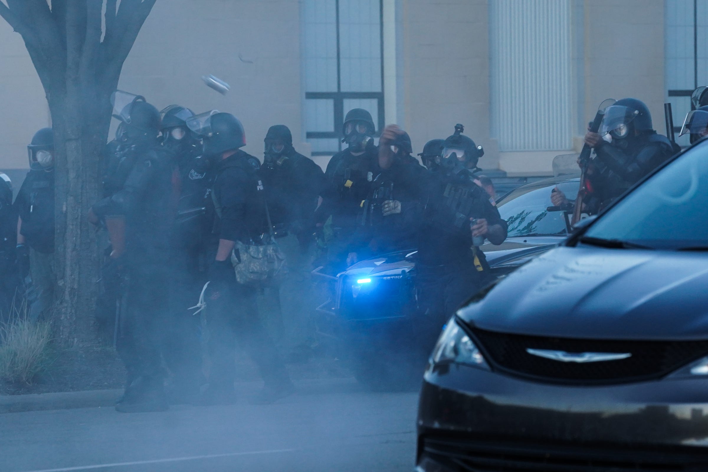 Police officers advance on protesters in downtown Detroit on Sunday, May 31, 2020 after they marched for the third day against police brutality and for justice for George Floyd in the city.