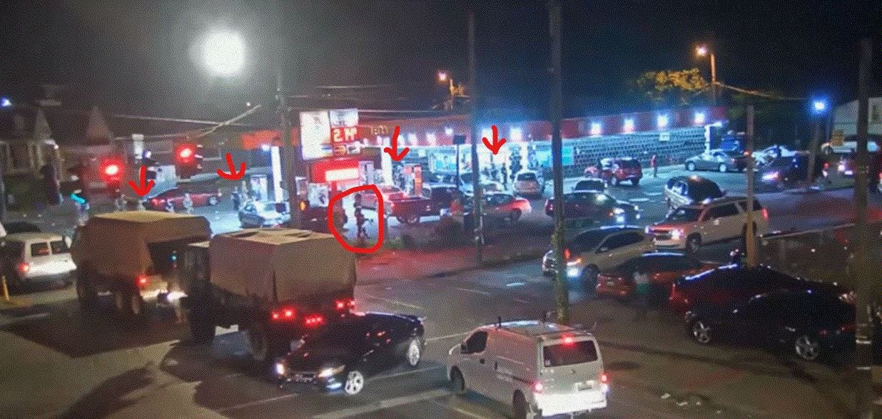 LMPD Officer Katie Crews walks along the eastern side of Dino's Food Mart parking lot while her fellow officers and National Guard members walk along the western edge. They were called to 26th and Broadway on June 1 to break up a "large crowd" after midnight.