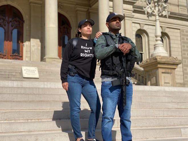 Michael Lynn Jr., right, and his wife Erica, stand on the steps of the State Capitol last month after helping to escort State Rep. Sarah Anthony into the building.