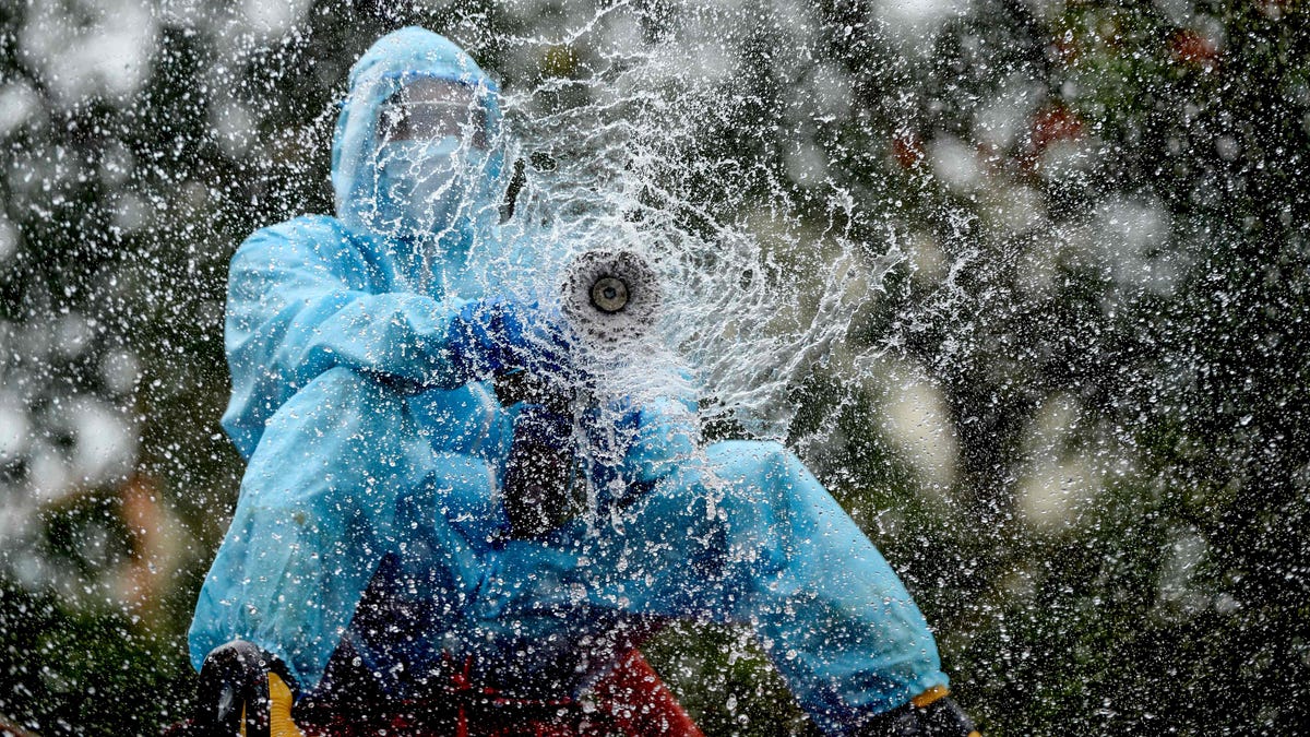 A firefighter sprays disinfectant as a preventive measure against the spread of COVID-19 in a containment zone in Chennai, India, on May 11.