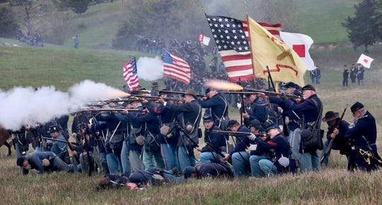 Union troops fire upon advancing Confederate troops during a reenactment of the Civil War Battle of Cedar Creek on Sunday Oct. 18, 2015, at the Cedar Creek battlefield just south of Middletown, Va. The 151st anniversary commemoration weekend was hosted by the Cedar Creek and Belle Grove National Historical Park.