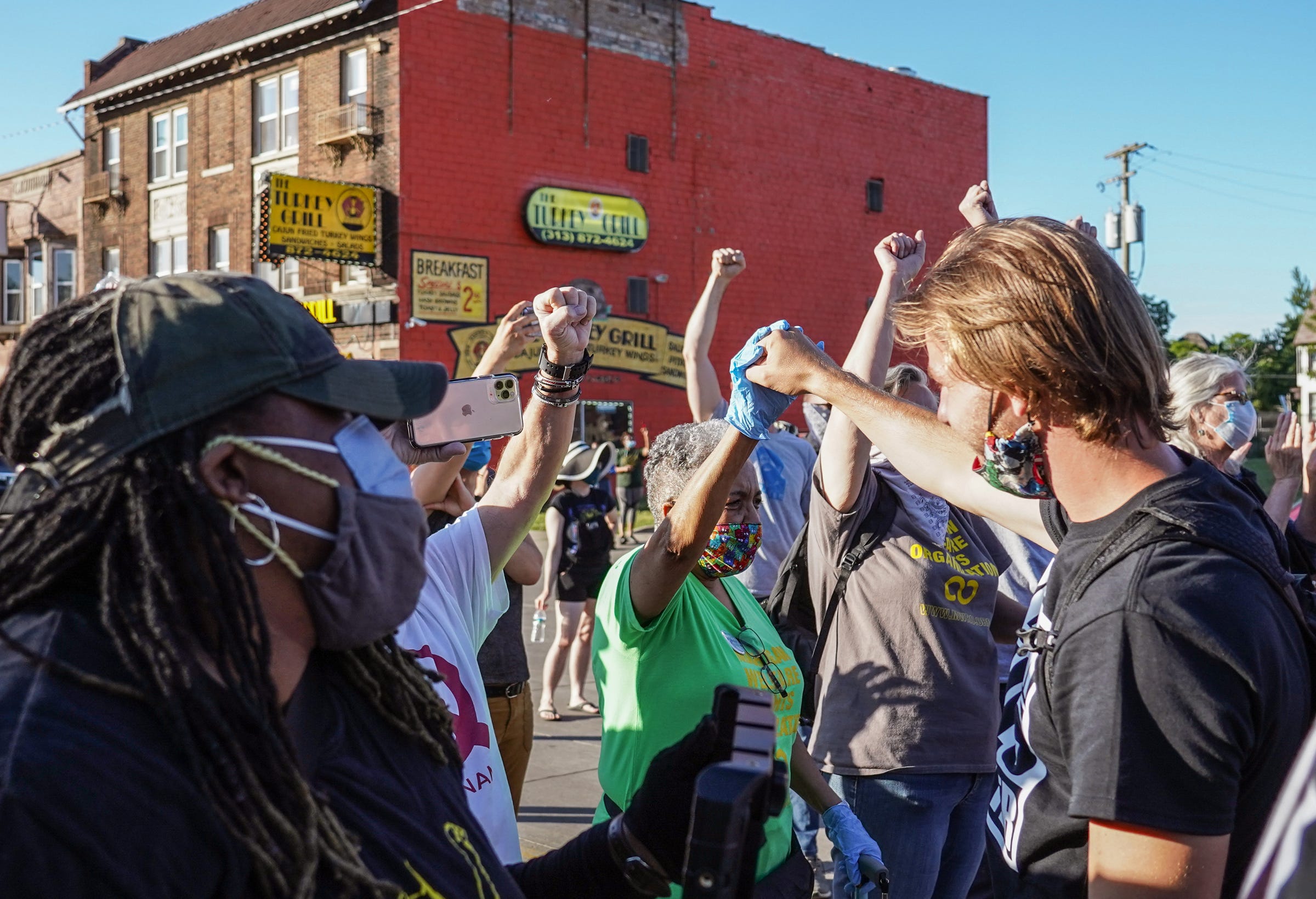 Protesters meet some elders at the site of the location of the Algiers Motel where three black men were shot during the uprising in 1967 before hearing their stories and words of encouragement during the eleventh day of protests against police brutality in Detroit on Monday, June 8, 2020.