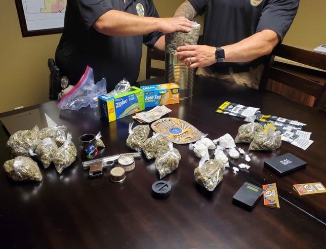 Medina Police log evidence after a narcotics search warrant that yielded four ounces of cocaine, around two lbs. of marijuana and a firearm.