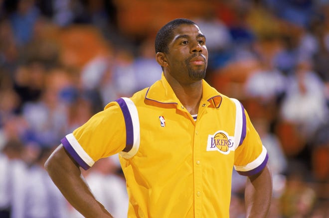 Magic Johnson of the Los Angeles Lakers stands during warm-ups before an NBA game at the Great Western Forum in Los Angeles in 1987.