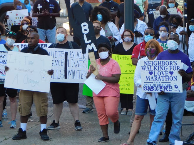 Protesters gather outside the St. Landry Parish Courthouse to rally last week against police brutality, with some calling for the firing of an Opelousas officer charged with assaulting a black teen.