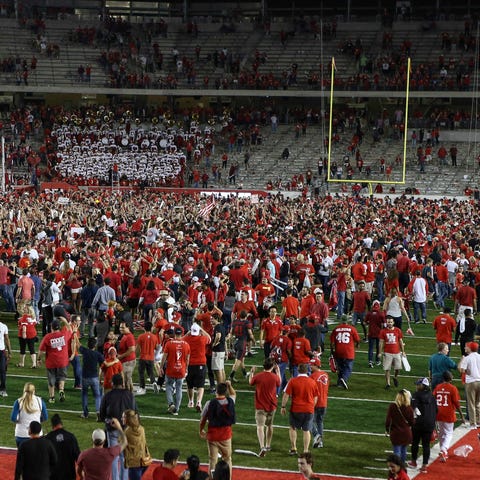 Fans run onto the field after the Houston Cougars 