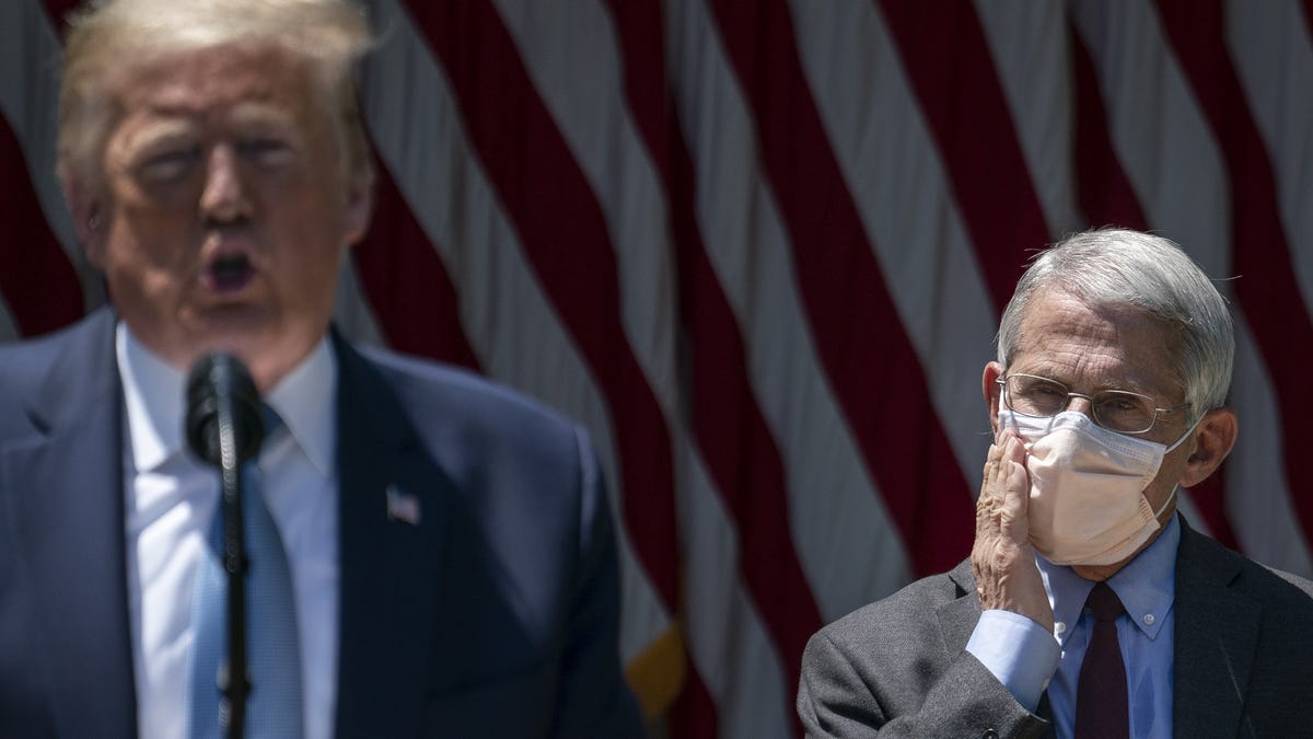 Dr. Anthony Fauci (R), director of the National Institute of Allergy and Infectious Diseases, looks on as U.S. President Donald Trump delivers remarks about coronavirus vaccine development in the Rose Garden of the White House on May 15, 2020 in Washington, DC.