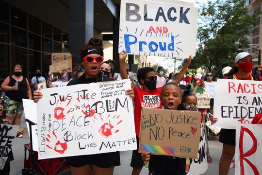 Amara Howard, 11, left, and Maiya Peacock, 11, right, march in Kids Walk for A Change in downtown Phoenix on June 13, 2020. The march was a 1-mile peaceful protest for kids and families supporting the Black Lives Matter movement and to help continue conversations about race with children.