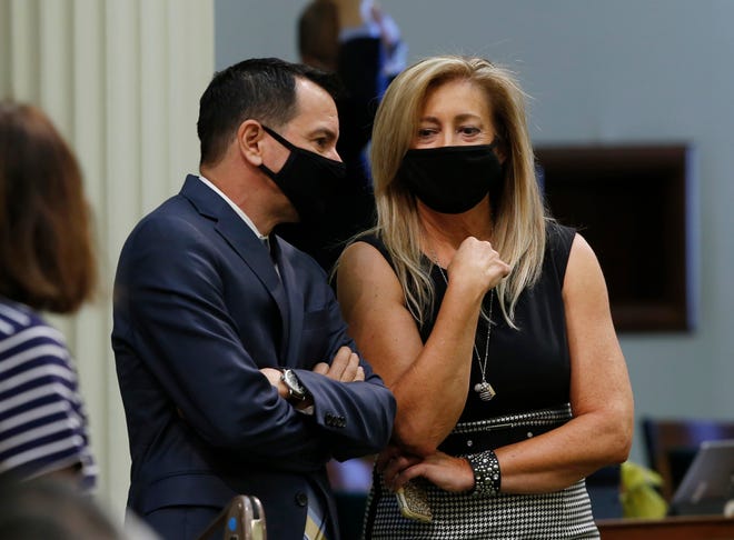 Assembly Speaker Anthony Rendon, D-Lakewood, left, talks with Assembly Republican Leader Marie Waldron, of Escondido, during the Assembly session in Sacramento in June.