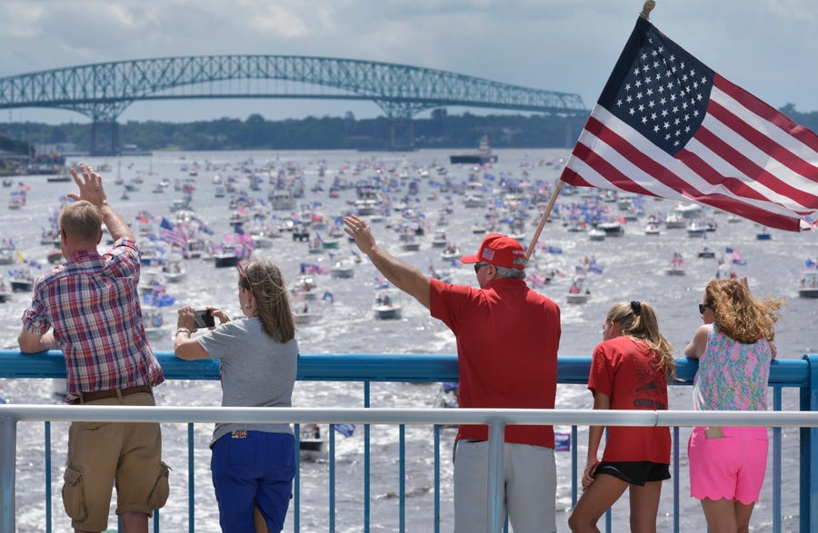 Supporters of President Donald Trump wave at the hundreds of boats idling on the St. Johns River during a rally Sunday, June 14, 2020, in Jacksonville, Fla., celebrating Trump's birthday.