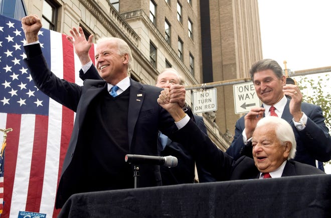 Democratic vice presidential candidate Sen. Joe Biden, D-Del., left, accompanied by, from second from left, Sen. Jay Rockefeller, D-W.Va., West Virginia Gov. Joe Manchin, and Sen. Robert Byrd, D-W.Va., gestures during a campaign rally in downtown Charleston, W.Va. Friday, Oct. 24, 2008.