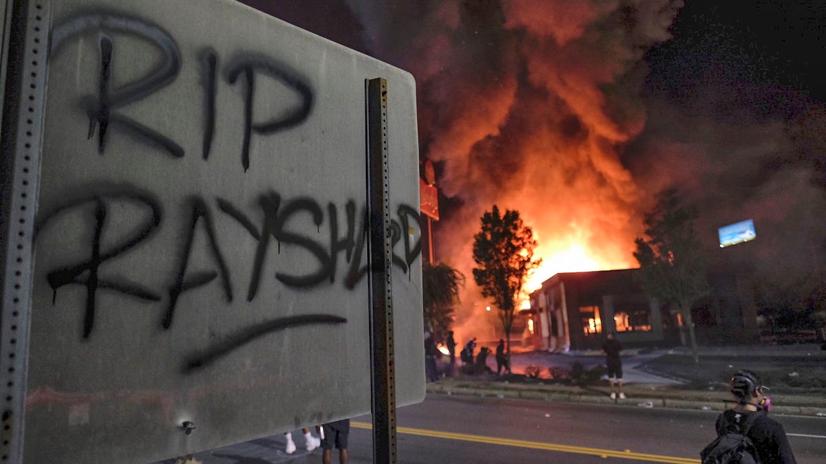 A Wendy's restaurant burns in Atlanta after demonstrators set it on fire Saturday night following the death of Rayshard Brooks, a Black man who was shot and killed by Atlanta police.
