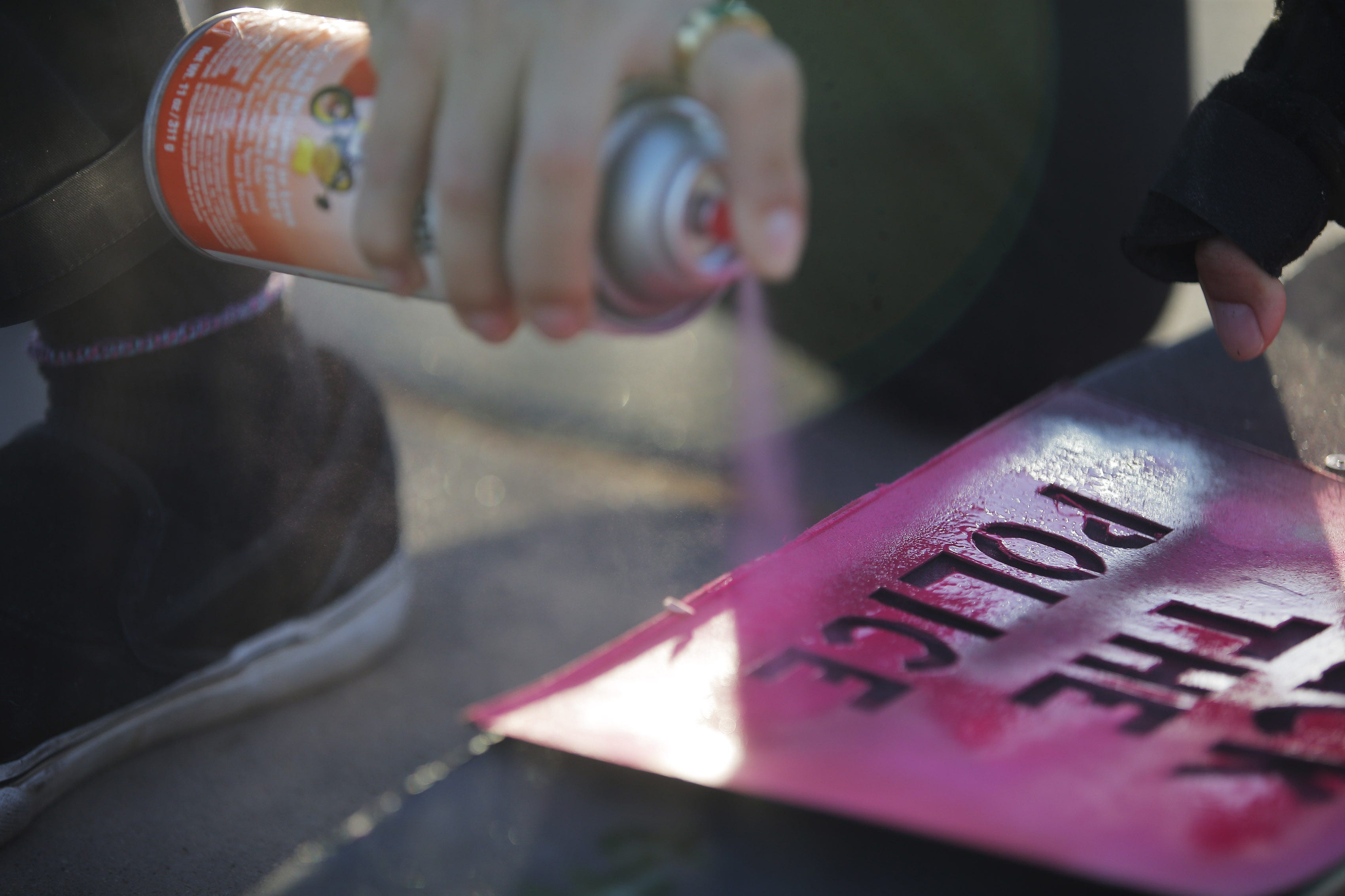 A protester paints a message before a skate against racial injustice in Phoenix on June 14, 2020.