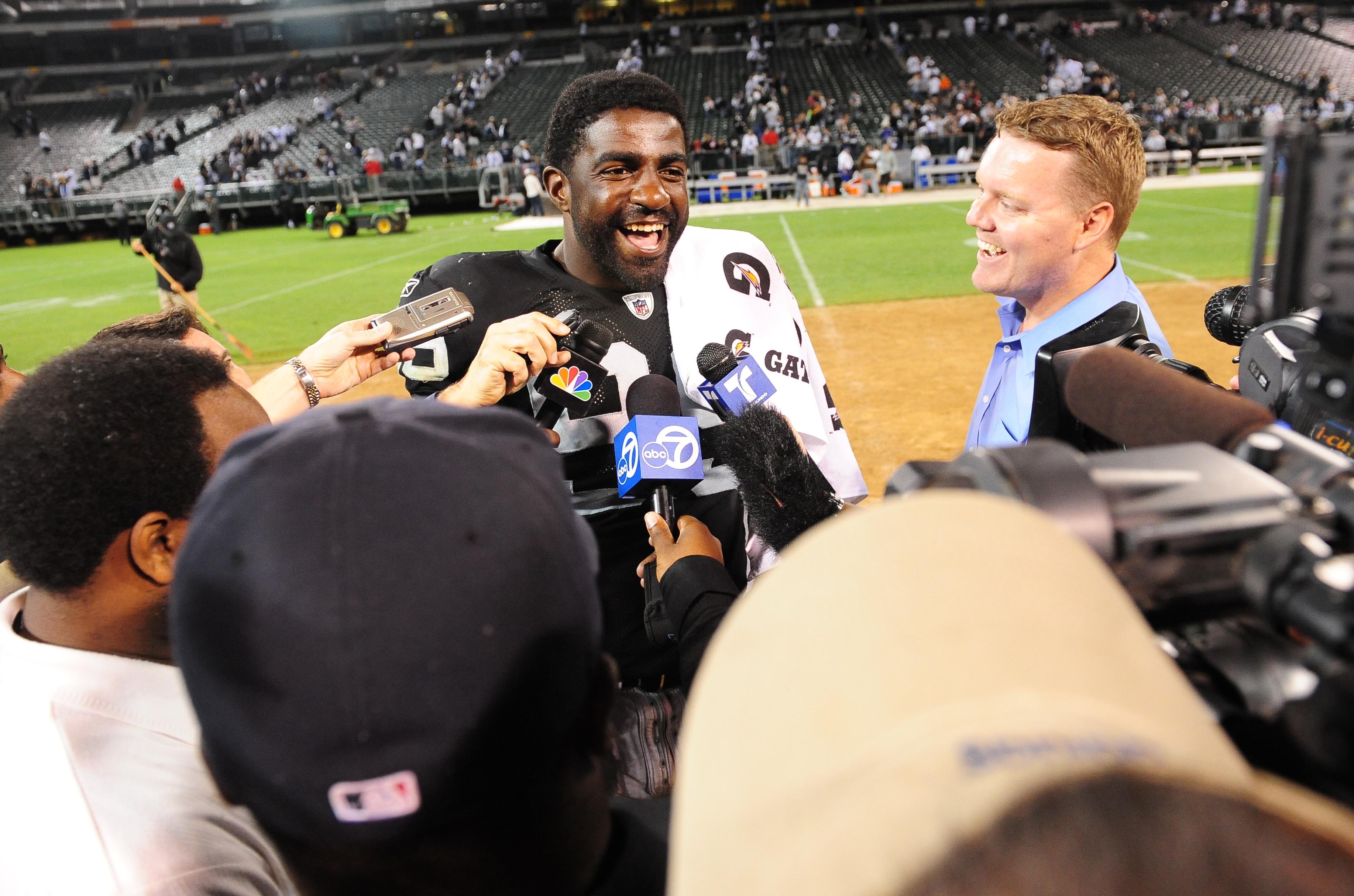 In this 2009 file photo, Oakland Raiders defensive end Greg Ellis talks to the media after a game against the Dallas Cowboys at Oakland-Alameda County Coliseum. The Raiders defeated the Cowboys 31-10.