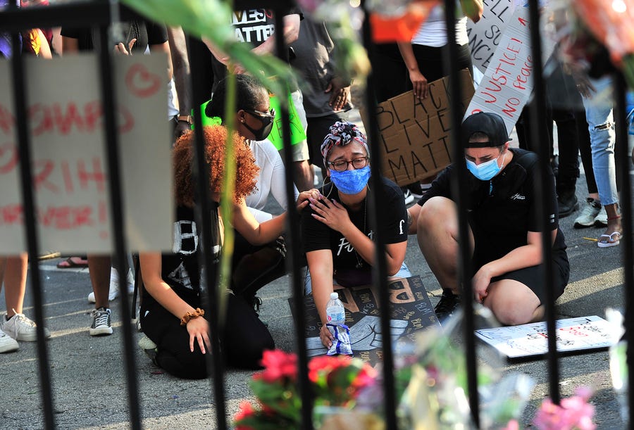 People mourn at a Wendy's restaurant  in Atlanta on June 14 after Rayshard Brooks was killed in a confrontation with police.