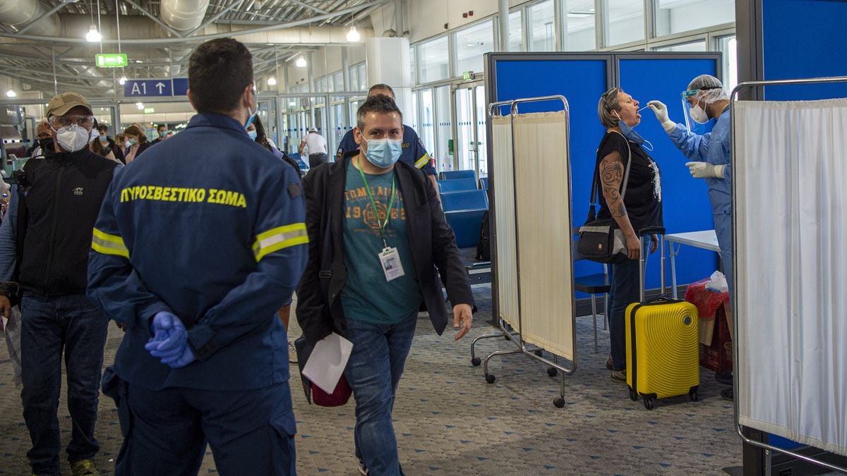 ATHENS, GREECE - JUNE 15: Medical staff conduct a test for the new coronavirus on the passengers who arrived from Rome to Eleftherios Venizelos International Airport on June 15, 2020 in Athens, Greece. The country removed most restrictions on travel from EU countries today in an effort to jumpstart its tourist season. Travelers from countries deemed high-risk, like the UK countries, will still face compulsory Covid-19 testing and mandatory quarantine. One week for a   negative result; two weeks for a positive result.