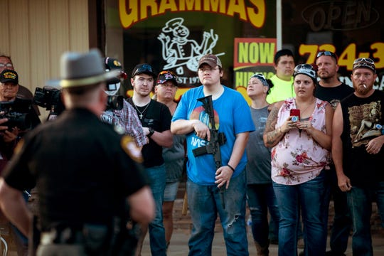 Counter protesters watch as Black Lives Matter protesters begin making their way to their homes as curfew approaches on Monday, June 15, 2020, along East Plane Street in Bethel, Ohio. Protesters took to the streets following the death of George Floyd, a Black man who died on Monday, May 25, 2020, in Minneapolis after a white police officer kneeled on his neck, ignoring Floyd's pleas that he could not breathe.