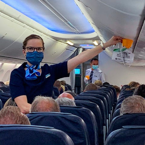 Masked stewardess on flight from Duesseldorf to Ma