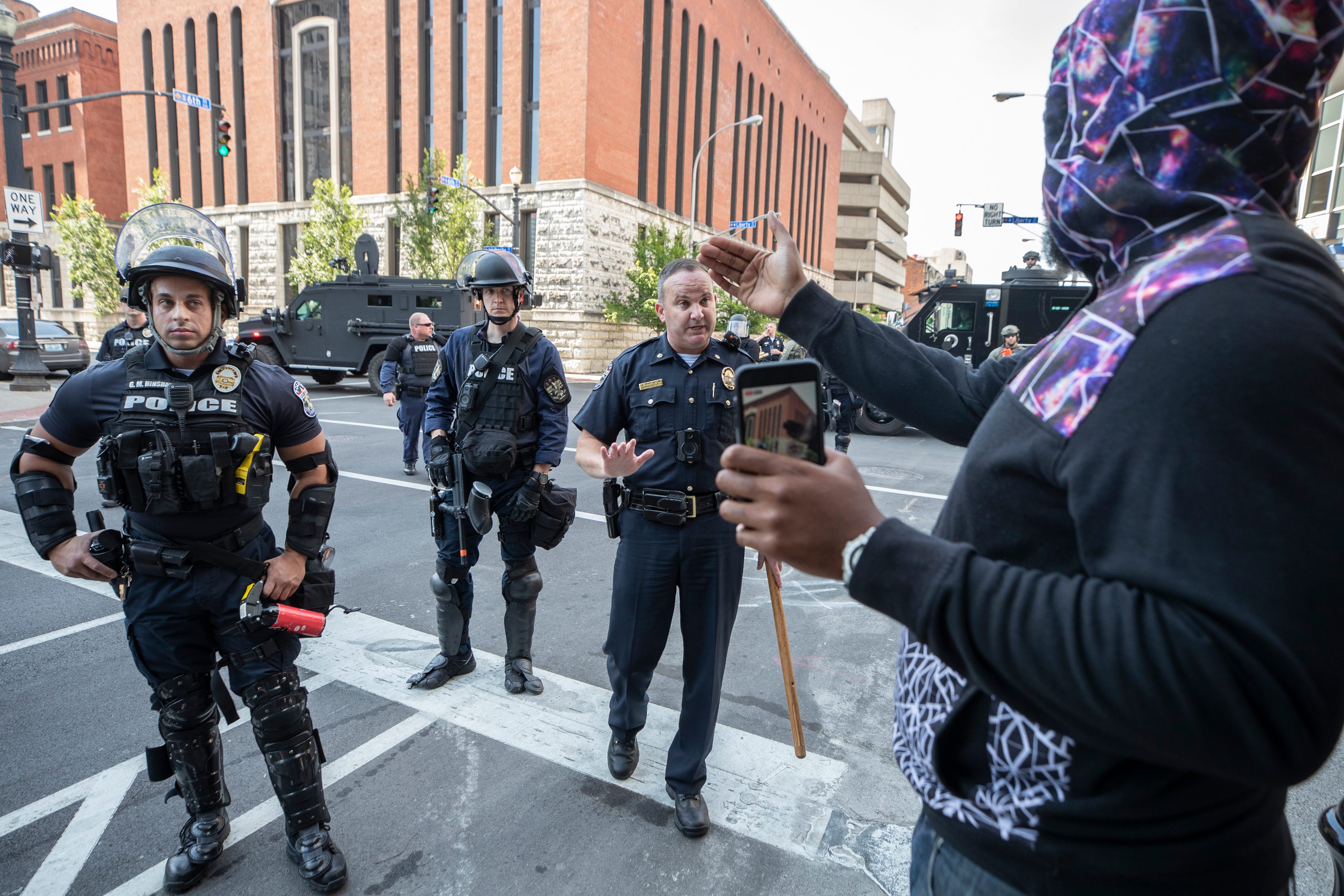 A protester talks with Louisville Metro police following a confrontation near Jefferson Square in downtown Louisville, Kentucky. June 17, 2020