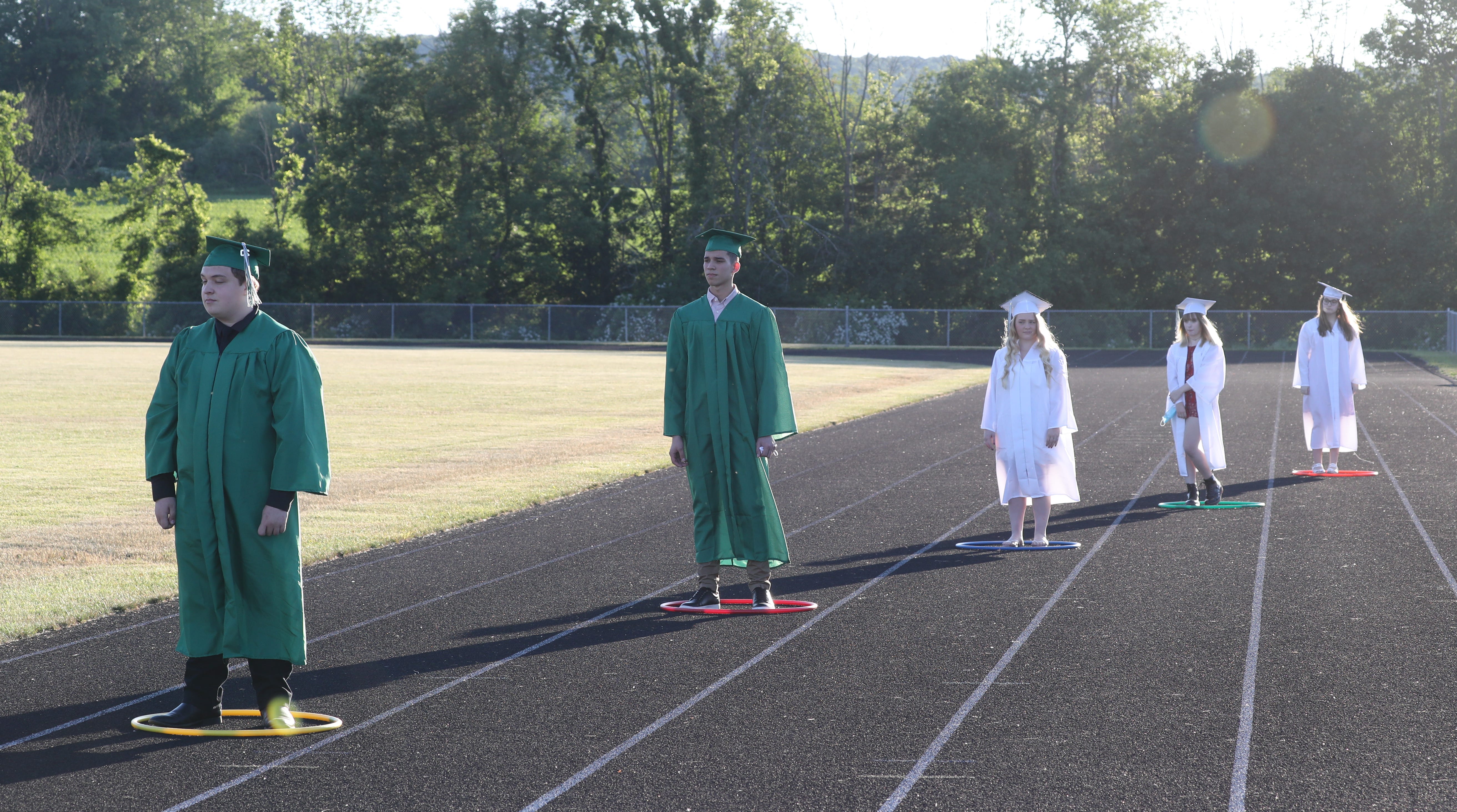 The pandemic completely changed high school graduations across New York in 2020. At Webutuck High School in June, graduates stand in hoops to maintain social distance while they wait to get their diplomas.