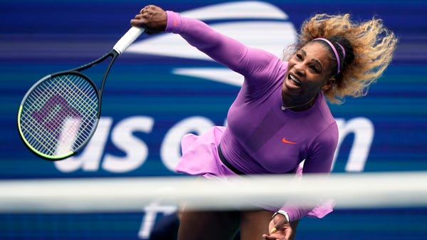 Serena Williams returns a shot to Bianca Andreescu