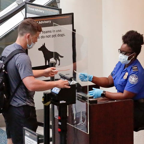 A traveler at Orlando International Airport lowers