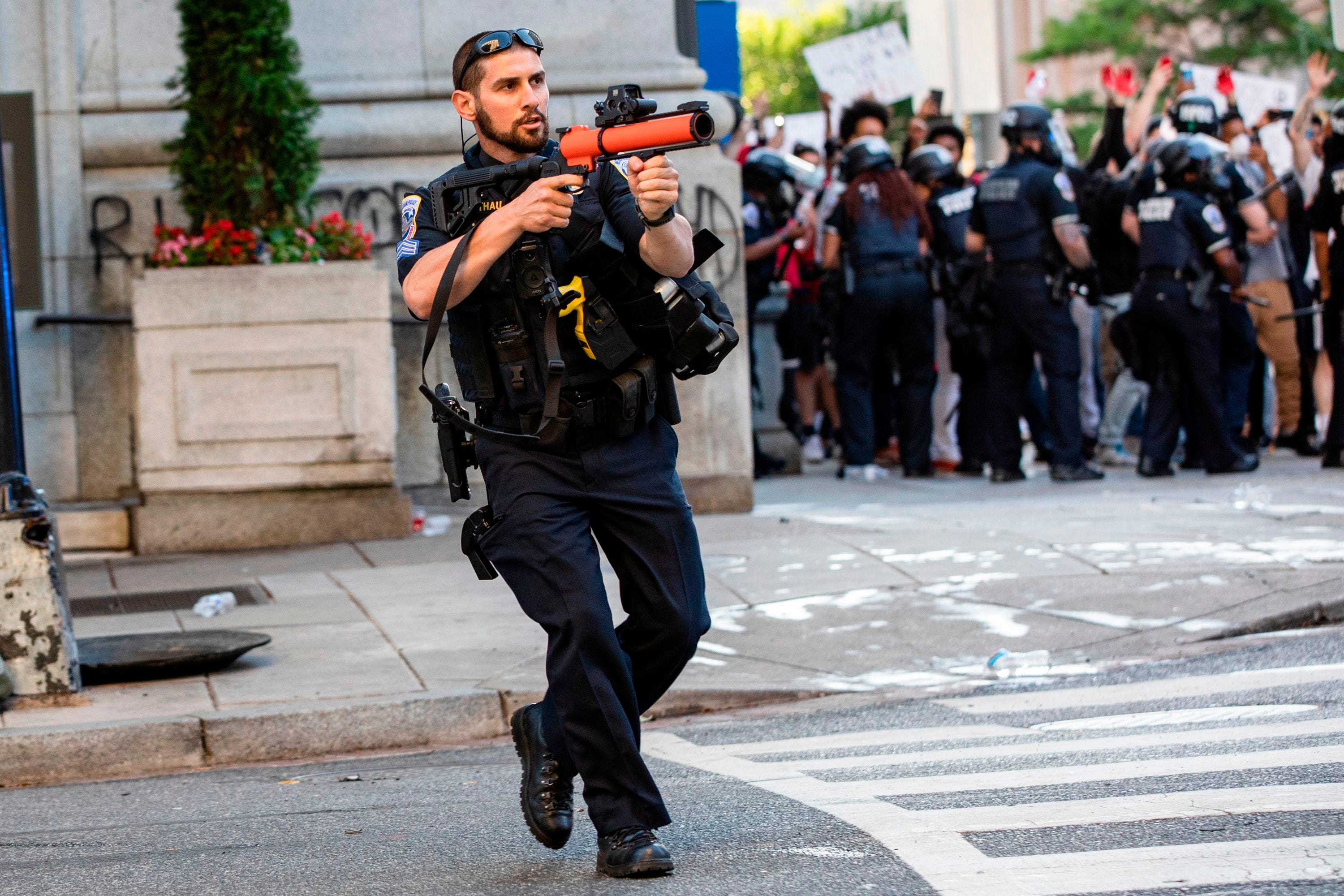 A DC Police officer aims a non-lethal launcher at protestors as they clash with Police after the death of George Floyd at the hands of Minneapolis Police in Washington, D.C. on May 31, 2020.