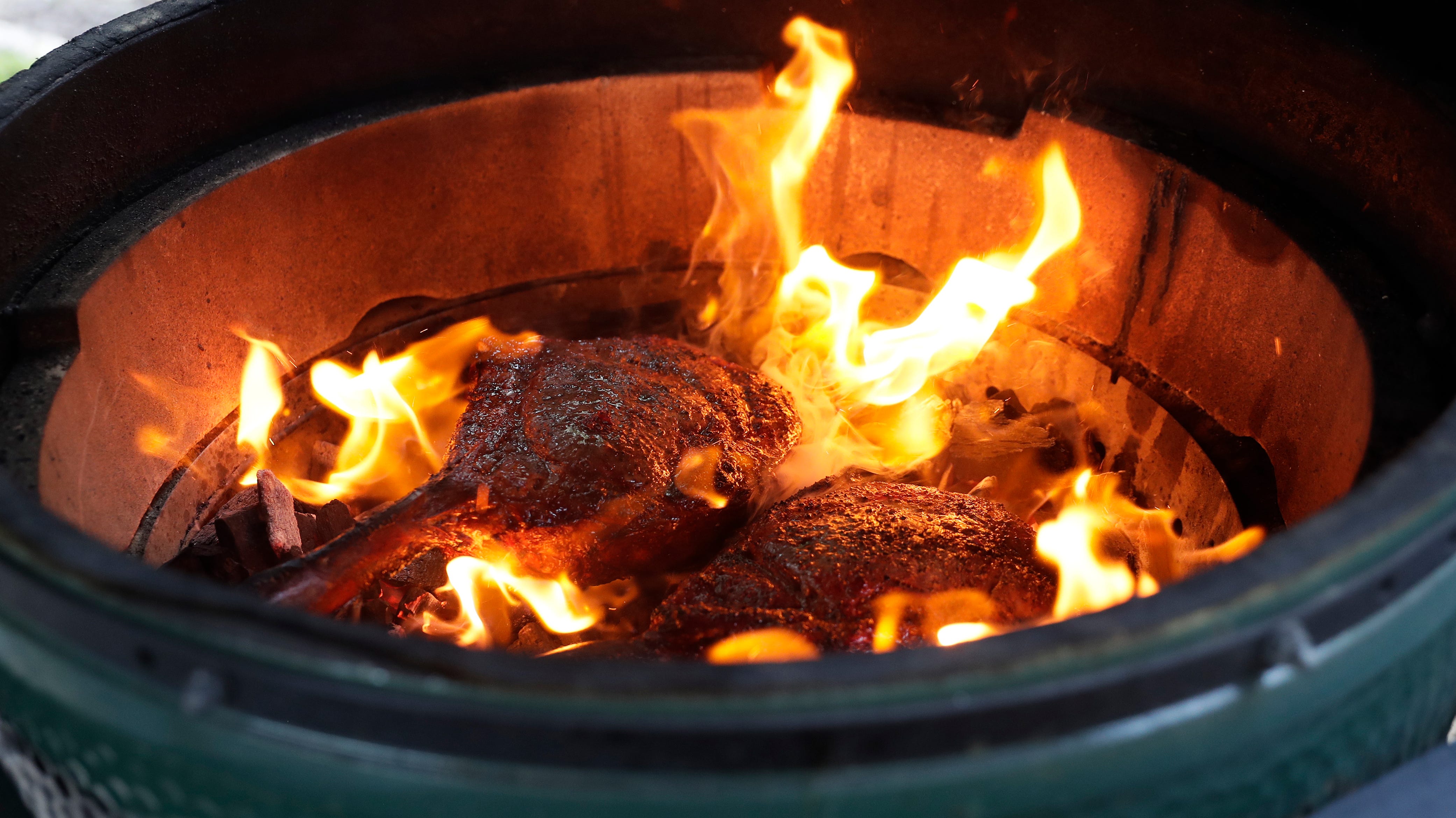 Tossing steaks on a hot bed of coals is one of Schemm's favorite grilling methods.