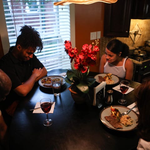 Omar Chatt eats dinner with his family in their Wi