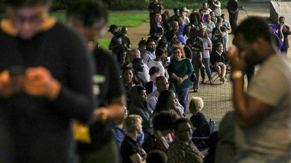People wait in line to vote Tuesday, March 3, 2020