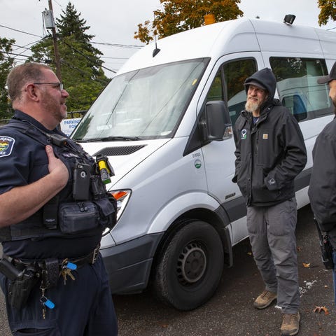 Eugene Police officer Bo Rankin, left, meets with 