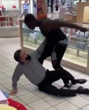 In a Twitter video, a Black man punches a white man several times. The caption with the social post read: "A man at a store in Flint allegedly referred to a Black man in the store as a 'n------' while talking on the phone. The Black man overheard him, then things went left."