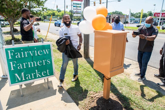 Jeremy Kelly reveals a new little library outside the Fairview Farmers Market in Montgomery, Ala., on Friday, June 19, 2020.