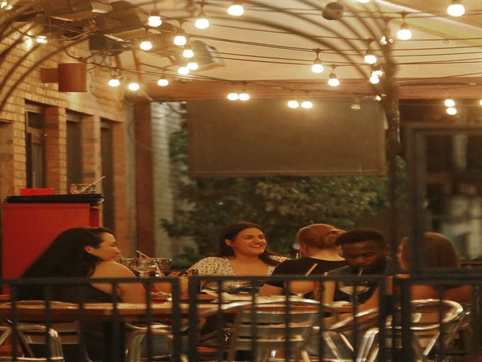 People gather to eat and drink on a Saturday night on Mill Avenue in Tempe on June 20, 2020.